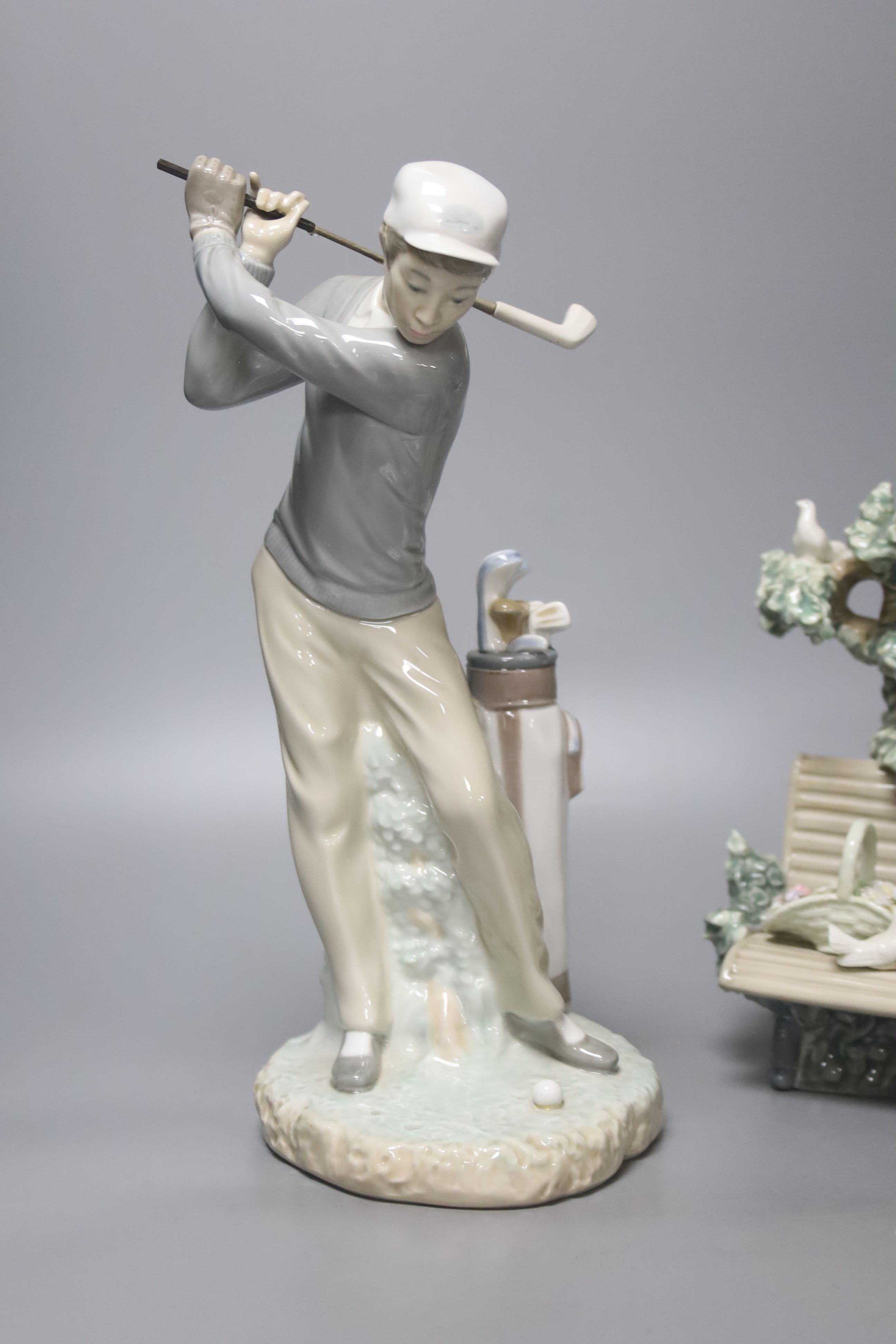 A Lladro figure, 'Sunday in the Park', no. 5365 and another 'Golfer', no. 4284 (2)